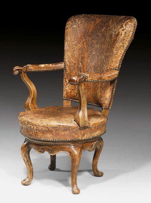 BUREAU-FAUTEUIL,Louis XV, Venice circa 1760. Carved walnut. Swiveling seat. Worn, original leather cover with decorative nail work. 55x50x44x98 cm.