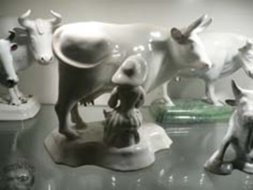 TWO WHITE COWS WITH A MILKMAID,