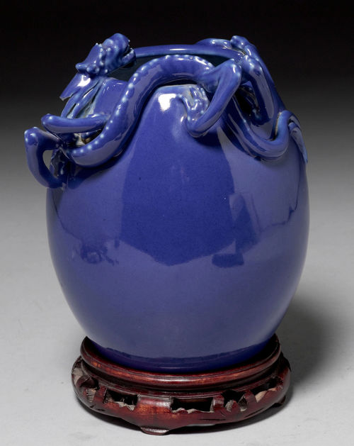 A MONOCHROME BLUE OVOID VASE WITH DRAGON AND BAT IN HIGH RELIEF.