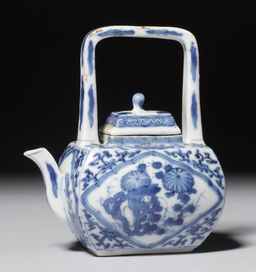 A BLUE-AND-WHITE CUBOID TEAPOT PAINTED WITH CARTOUCHES OF FLOWERS AND CLOUDS. China, Kangxi period, Height 10 cm. Lid glued.