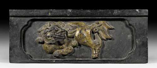 A BRONZE RELIEF PANEL DEPICTING A LION.