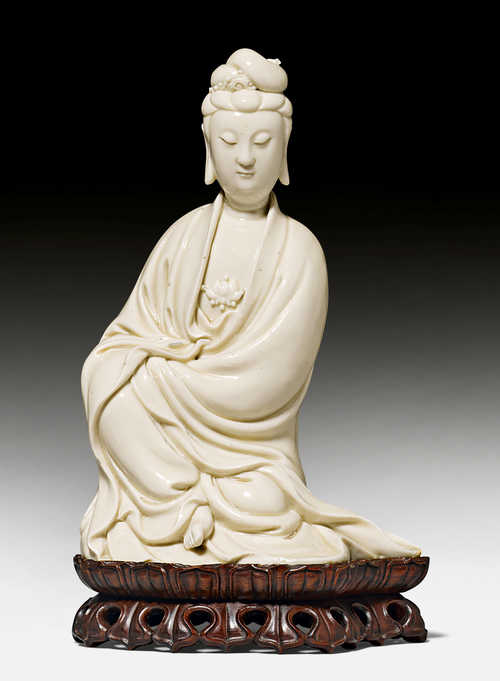 A DEHUA FIGURE OF THE SEATED BODHISATTVA GUANYIN. China, He Chaozong ...