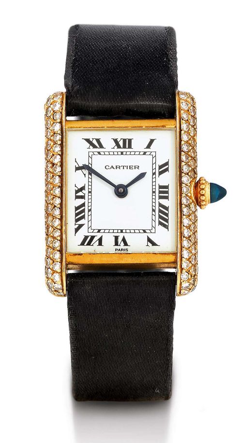 CARTIER TANK DIAMOND LADY'S WRISTWATCH, HAND WINDER, 1980s. Yellow gold 750. Ref. 933, rectangular case No. 780870054 J set throughout with diamonds, gold crown with sapphire cabochon. White dial with black Roman numerals and blued hands. Hand winding movement Cal. ETA 2512. Black satin band with gold Cartier fold-over clasp. D 28 x 21 mm.