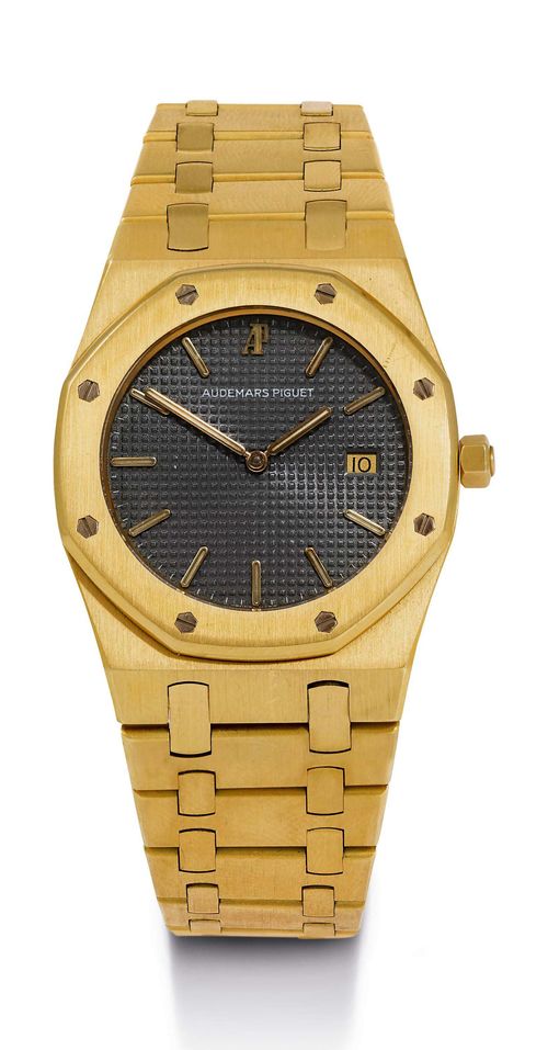 ELEGANT AUDEMARS PIGUET ROYAL OAK QUARTZ WATCH, CA. 1988. Yellow gold 750. Flat, distinctive case No. 610, polished. Screwed lunette with sapphire glass, back with engraved dedication. Anthracite-coloured dial with "Clous-de-Paris" decoration, applied gold luminous indices and gold hands, date at 3h. Ultra-flat quartz movement Cal. 2612. Polished gold link band with fold-over clasp. D 33 mm.