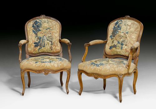 PAIR OF TAPESTRY FAUTEUILS "A LA REINE", Louis XV, signed LE BAS (Jean-Baptiste Lebas, maître 1756), Paris ca. 1750. Moulded beech wood, finely carved with flowers, leaves and ornamental frieze. Fine tapestry cover with fanfares, flowers and ornamental frieze with bullen nails. 67x54x44x98 cm. Provenance: - from a Swiss private collection.