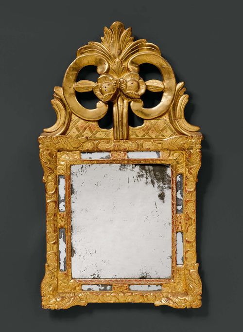 MIRROR, Louis XV, France ca. 1760. Wood carved with flowers, leaves, volutes and decorative frieze, and gilt. Rectangular, shaped, partly mirrored frame with open-worked volute top. Minimal chipping. H 75 cm. W 41 cm. Provenance: - from the estate of M. Iseli-Mooser, Suisse romande.