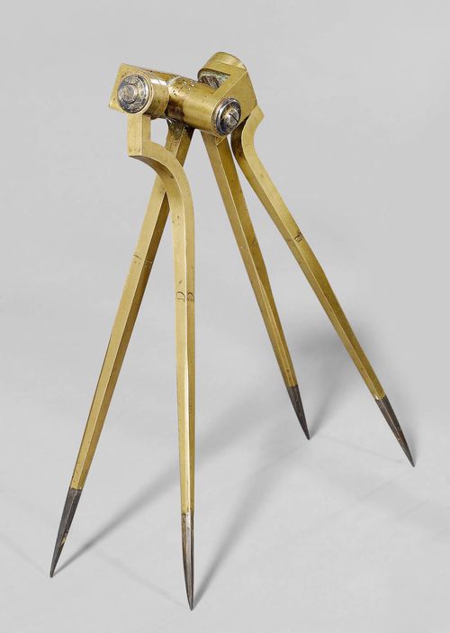 A PAIR OF RARE BRASS AND STEEL DIVIDERS, France, circa 1850. The four legs meet in a barrel shaped triple joint and are inscribed A, B, C and D. L 26 cm.