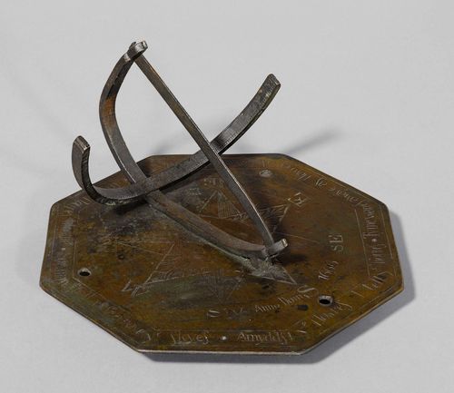 AN ENGLISH GARDEN SUNDIAL, bearing date 1666. Bronze with engraved compass rose and motto. 25.5x25.5 cm.