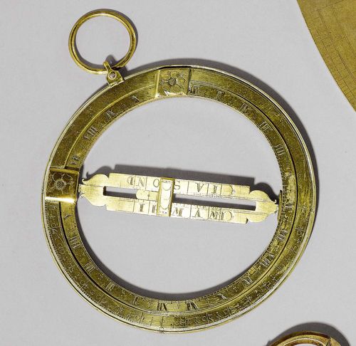 AN ENGRAVED BRASS RING DIAL, France, 18th c. Meridian ring with latitudes; the equatorial ring with engraved dial and calendar scale. D 15.5 cm.