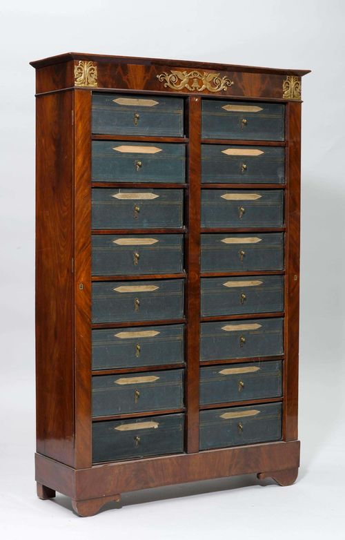 CARTONNIER FILING CABINET,late Empire. Mahogany. Rectangular body. Front with 16 hinged drawers arranged in 2 rows and covered with green leather. 100x34x156.5 cm. 1 key.