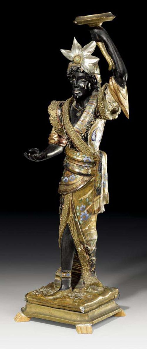 PAINTED PORTE-TORCHERE "A L'INDIEN",late Louis XV, Venice, 19th century Carved and polychrome painted wood in the form of a standing figure in bright garments. Some losses. H 93 cm. Provenance: from a German private collection.