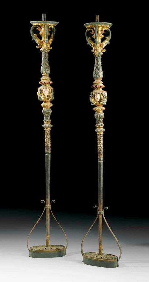 PAIR OF PAINTED PORTE-TORCHERES,late Baroque, Venice, 18/19th century Wood, richly carved with angels, flowers and frieze, polychrome painted and parcel gilt. The shaft set in a green-painted iron holder. H 267 cm. Provenance: Private collection, Brissago.