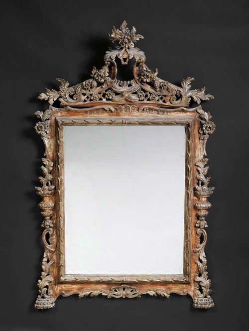 PIERCED AND CARVED MIRROR, Late Baroque, Venice, 18th/19th century With flowers, leaves, scrolls and frieze and traces of old silvering. With cartouche shaped cornice. H 130 cm, W 82 cm. Provenance: - Galerie Koller Zürich 18.3.1998 (Lot No539). - Private collection, Meggen.