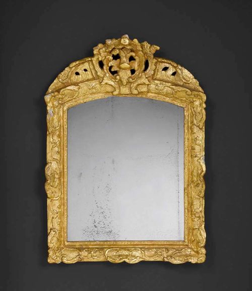 SMALL PIERCED AND CARVED GILTWOOD MIRROR,Régence, France, 18th century Some losses. H 81 cm, W 57 cm. Provenance: from a German collection.