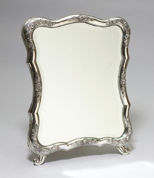 STANDING MIRROR,Austria, 1866-1922. With maker's mark. Curved rim with floral decoration. Ca. 37 x 49 cm.