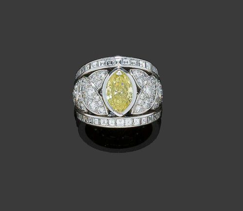 DIAMOND RING, PÉCLARD. White gold 750. Elegant band ring, the fine floral open-worked top set with 1 navette-cut diamond of 1.76 ct., Fancy Yellow/P1, flanked by brilliant-cut diamond leaf motifs totalling ca. 1.09 ct. The rim set with 38 Princess-cut diamonds totalling 1.69 ct. Size ca. 49. With copy of invoice and Gemlab Diamond Report No. 1544, 2007.