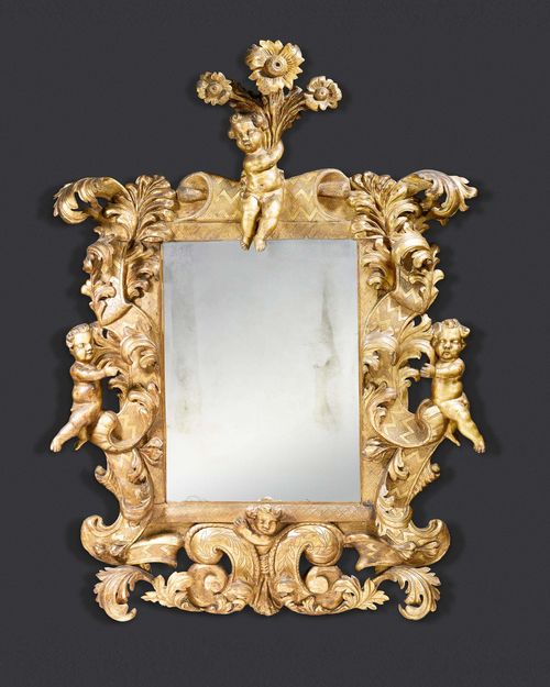 IMPORTANT MIRROR "AUX ANGELOTS", Baroque, northern Italy circa 1750. Pierced and richly carved wood. Repairs and some losses. H 145 cm, W 114 cm. Provenance: - Galerie Koller 19.6.2008 (Lot No. 1046). - From an important European private collection.