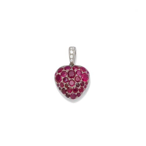RUBY AND DIAMOND PENDANT, ca. 1960. Platinum and white gold 750. Decorative, heart-shaped pendant set throughout with numerous rubies weighing ca. 5.00 ct, probably untreated, the eyelet additionally decorated with 4 brilliant-cut diamonds weighing ca. 0.10 ct. L ca. 2 cm.