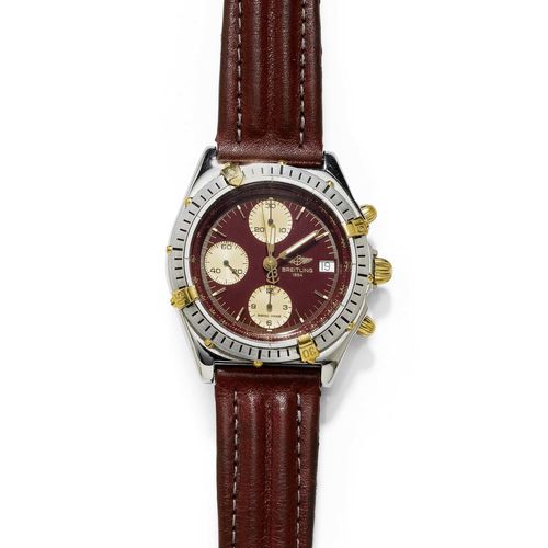 GENTLEMAN'S WRISTWATCH, CHRONOMAT, BREITLING. Steel and yellow gold. Ref. B13048. Polished, tonneau-shaped case No. 1 37397, unilaterally rotatable lunette with 4 appliqued gold tabs, screw-down crown. Burgundy-coloured dial with luminous indices and luminous hands, gold-coloured numerals, central second, date at 3h, signed Breitling 1884. Automatic, Cal. Valjoux 7750, Chronograph, 25 rubies. Burgundy leather band with Breitling clasp. D 39 mm. With case, warranty and Breitling fold-over clasp.
