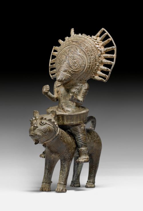 A BHUTA BRONZE FIGURE OF PANJURLI ASTRIDE A LEOPARD.