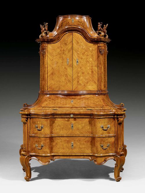 SMALL BUREAU CABINET,known as a "Cantourgen", Baroque, attributed to F.A. HERMANN (Franz Anton Hermann, active from 1724), Mainz   1740/60. Walnut in veneer, finely inlaid with lozenge pattern and decorative frieze. Hinged writing surface above commode lower section with 2 drawers below pull-out shelf. Fitted interior with large compartment and formerly 2 side drawers. The recessed upper section with double doors below a top drawer. Bronze mounts. Over-restored and partly heavily supplemented. 118x70x(open 81)x198 cm. Provenance: - Former German aristocratic collection, Mainz. - Swiss private collection.