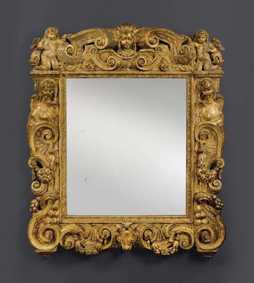 LARGE MIRROR "AUX ANGELOTS",Late Baroque, northern Italy, 19th century. Pierced and richly carved giltwood. Some losses. H 163 cm. W 140 cm. Provenance: - Formerly in the collections of the Grand Casino in Montreux. - German private collection.