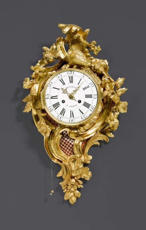 CARTEL CLOCK "AU PERROQUET",Louis XV, the dial signed MICHEL A DIJON, Paris circa 1760. Gilt bronze. Enamel dial and 2 fine gilt hands. Anchor escapement striking the 1/2 hours on bell. Repeat function. Requires servicing. H 59 cm. W 36 cm.