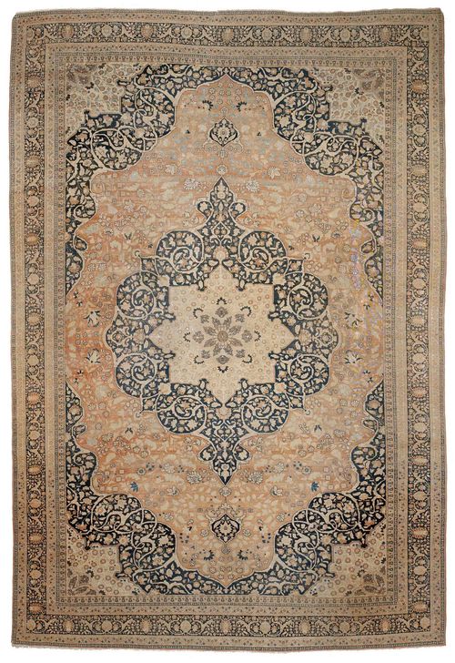 TABRIZ antique.Beige and black central medallion on a rust coloured and black ground, the entire carpet is patterned with trailing flowers and palmettes, black edging, strong signs of wear, 290x420 cm.