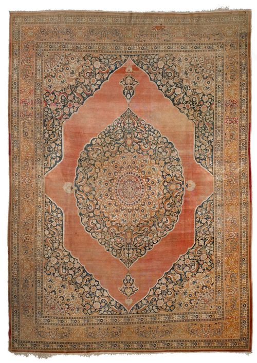 TABRIZ antique.Dark blue central field with a pink central medallion and beige corner motifs, finely patterned with trailing flowers and palmettes in delicate pastel colours, pink edging, signs of wear, 350x456 cm.