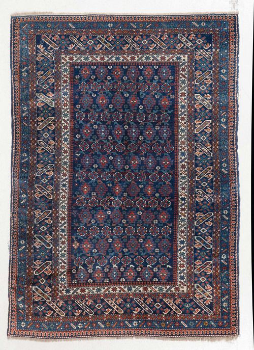 TCHI-TCHI old.Dark blue central field, geometrically patterned with stylized blossoms, stepped edging with tendrils, 128x175 cm.