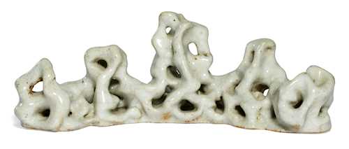 A SCHOLAR'S ROCK PORCELAIN BRUSH REST.