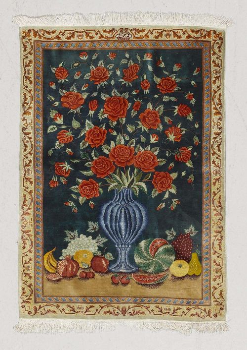 GHOM SILK PICTORAL CARPET.Blue ground with a vase and fruit, beige border, 67x97 cm.