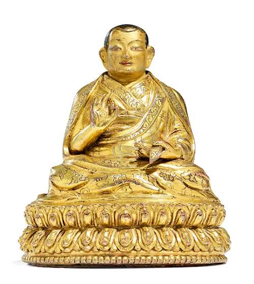 A GILT COPPER ALLOY FIGURE OF A HIGH RANKING LAMA.