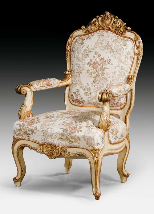 LARGE FAUTEUIL "AUX CARTOUCHES",Napoleon III, probably Venice circa 1850. Exceptionally finely carved and gilt wood. Light beige silk cover with polychrome flowers and leaves. 75x58x50x123 cm.