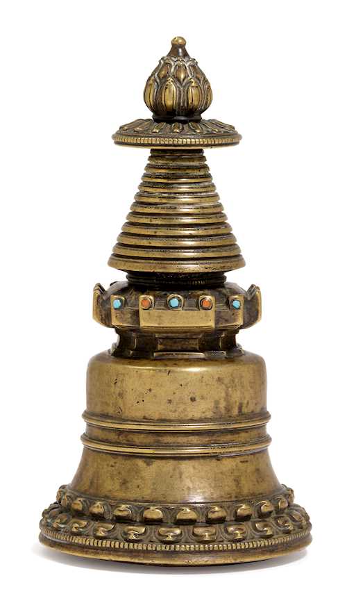 A BRONZE KADAMPA STUPA.