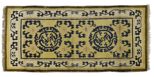 A YELLOW GROUND NINGXIA CARPET WITH BLUE DRAGON ROUNDELS. China, around 1800, 161x77 cm. Traces of use.