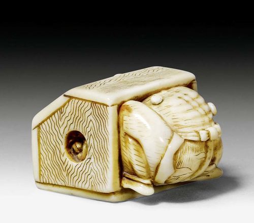 A FUNNY IVORY NETSUKE OF A ONI TRYING TO HIDE. Japan, Meiji period, length 3.2 cm.