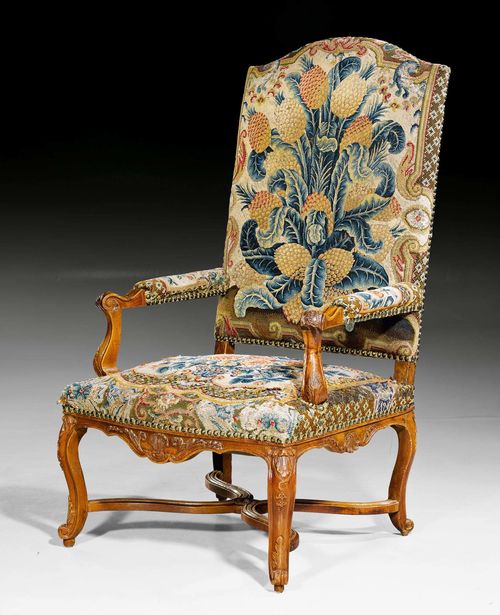 LARGE TAPESTRY FAUTEUIL, Regence, Paris circa 1730. Finely carved walnut. Fine tapestry cover with flowers and leaves. 68x63x45x128 cm.