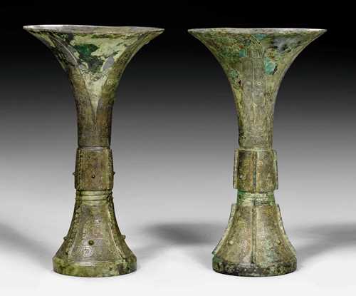 A FINE AND RARE PAIR  OF "GU" TYPE BRONZE VASES. China, late Shang dynasty, height 28 cm. Pictograph in the foot.