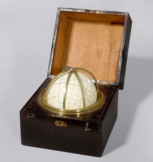A TERRESTRIAL GLOBE, England, circa 1900. Sign. CARY LONDON PATENT NO 21540. Cardboard sphere with coloured paper, brass meridian ring. In mahogany case with etiquette ULLYET COLLECTION 1039, 22x22x22 cm.
