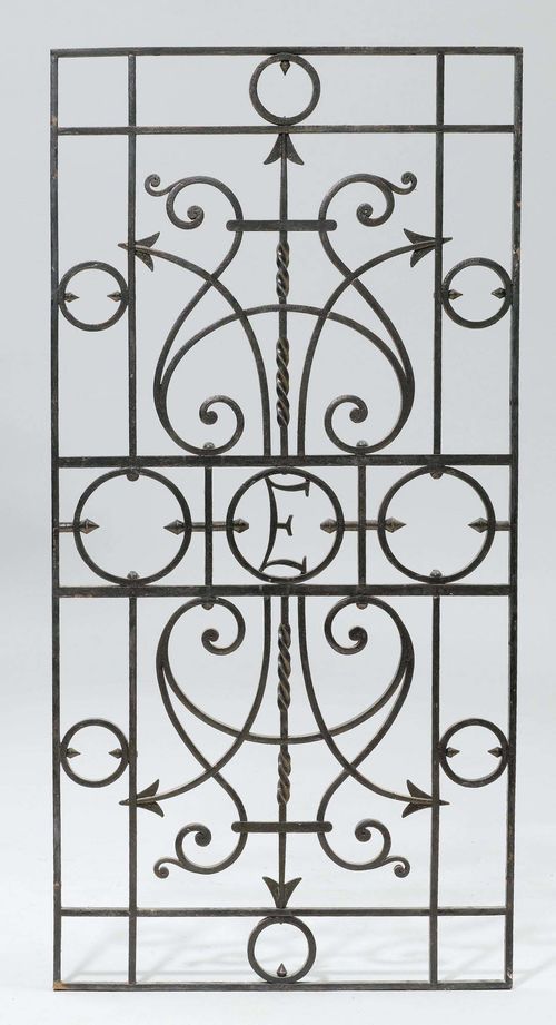 WROUGHT IRON GRID,first half of the 20th century. From the "Haus zum Elsässer" in Zurich. Rectangular, open-worked and adorned with volutes and arrows. In the centre: the letter "E". 120x59 cm.