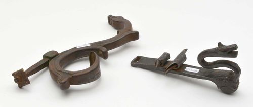 2 DOOR KNOCKERS,probably from the southern Alpine region, 17th century. Wrought iron. The ends designed as snakes. L 21-24 cm.