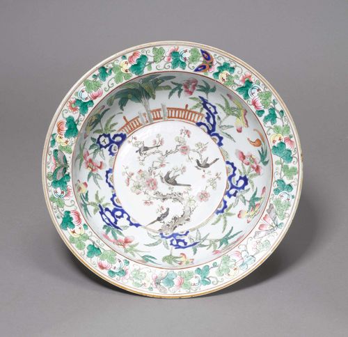 DEEP BOWL.China, ca. 1900, D 37 cm. Decorated in famille rose colours with four magpies on a flowering plum branch in the well, a garden landscape on the cavetto, and pumpkins with four butterflies on the rim.