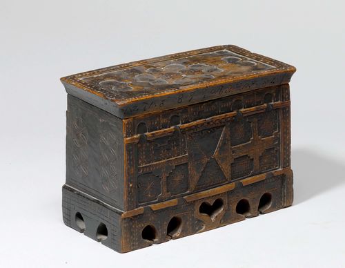 MINIATURE CHEST,probably Grisons, dated 1689. Blackened wood, carved. Rectangular body with hinged lid. 26 x 14 x 18 cm.