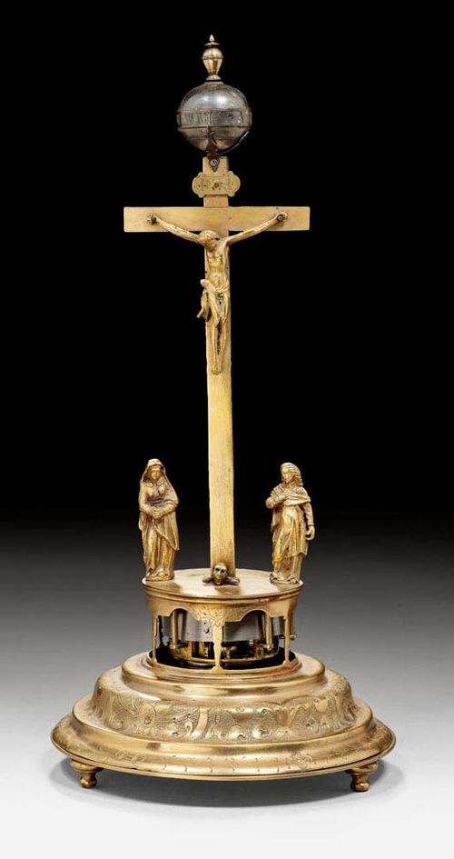CRUCIFIX CLOCK,Renaissance style, with signature under a movement wheel, probably Augsburg, 19th century, the movement older. Gilt bronze. Verge escapement striking on bell. Alarm clock. H 32 cm.