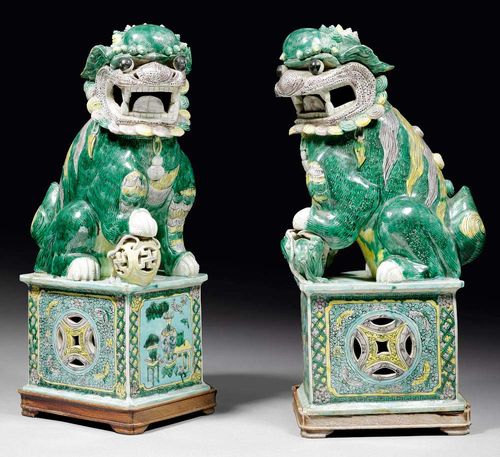 PAIR OF LARGE LIONS.China, 19th century H 50 cm. Glazed in green, yellow and aubergine. One lion with repaired head, the other with damage to leg and several chips. (2)