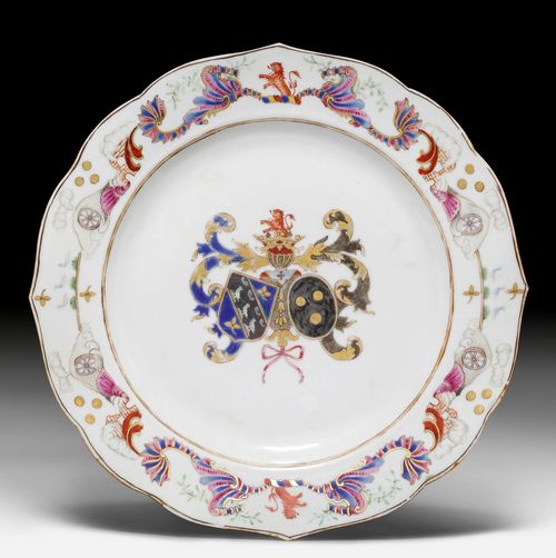 AN ARMORIAL PLATE IN FAMILLE ROSE COLOURS, GOLD AND SILVER, SHOWING TWO COATS OF ARMS WITH A LION, ACCOMPANIED BY SCENES OF BRICK KILNS AND WATERWHEELS. China, Export ware for Europe, Qianlong Period, Diameter 23 cm. Minor chipping.