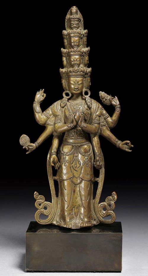 COPPER ALLOY FIGURE OF ELEVEN HEAD AVALOKITESHVARA. With remains of gilding. The main hands holding a jewel. East Tibet, 18th century. H 23.5 cm.