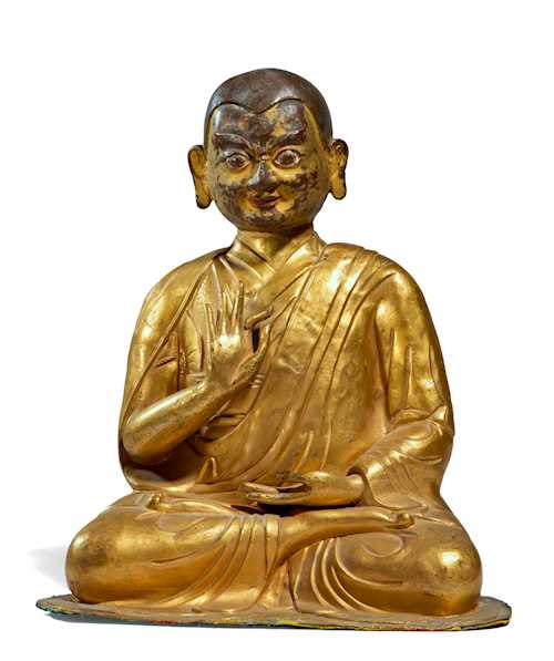 A GILT COPPER REPOUSSE FIGURE OF A LUOHAN.