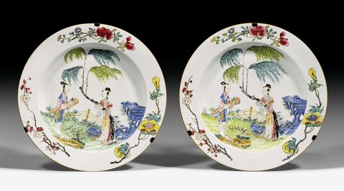 A PAIR OF FAMILLE ROSE DISHES DECORATED WITH TWO LADIES IN A GARDEN. China, Yongzheng period, diameter 35 cm. One very minor chip.